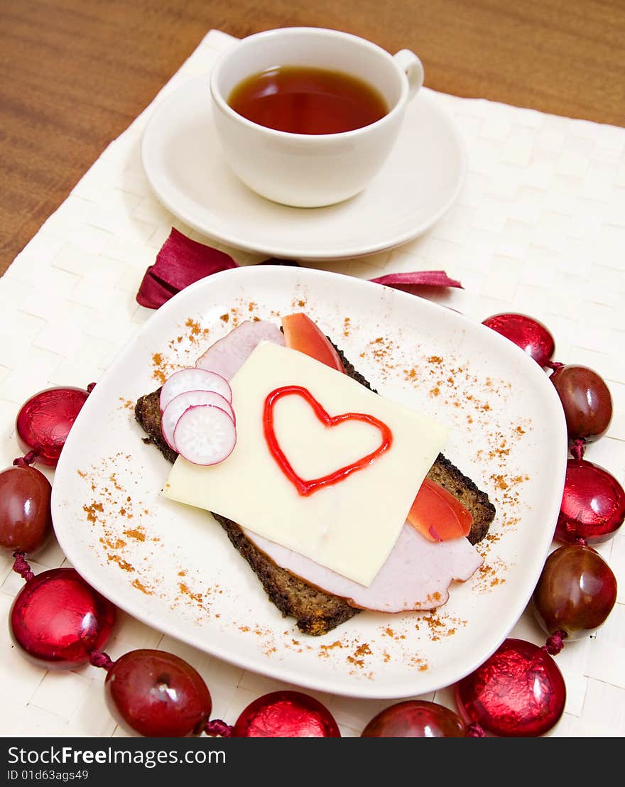 Valentines sandwich with a tea on a table. Valentines sandwich with a tea on a table