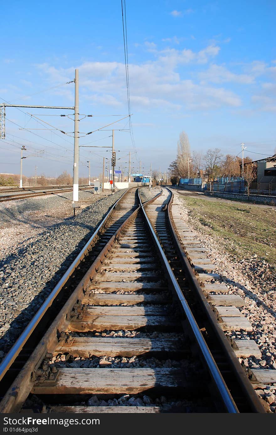 A railway switch and blue sky. A railway switch and blue sky