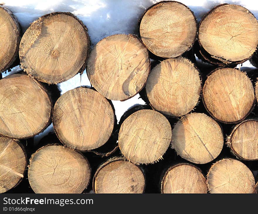 Firewood under snow as a background