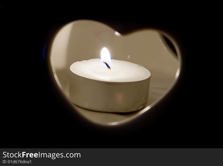 Burning candle in heart candlestick. Burning candle in heart candlestick