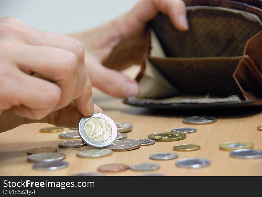 Woman considers coins in its purse