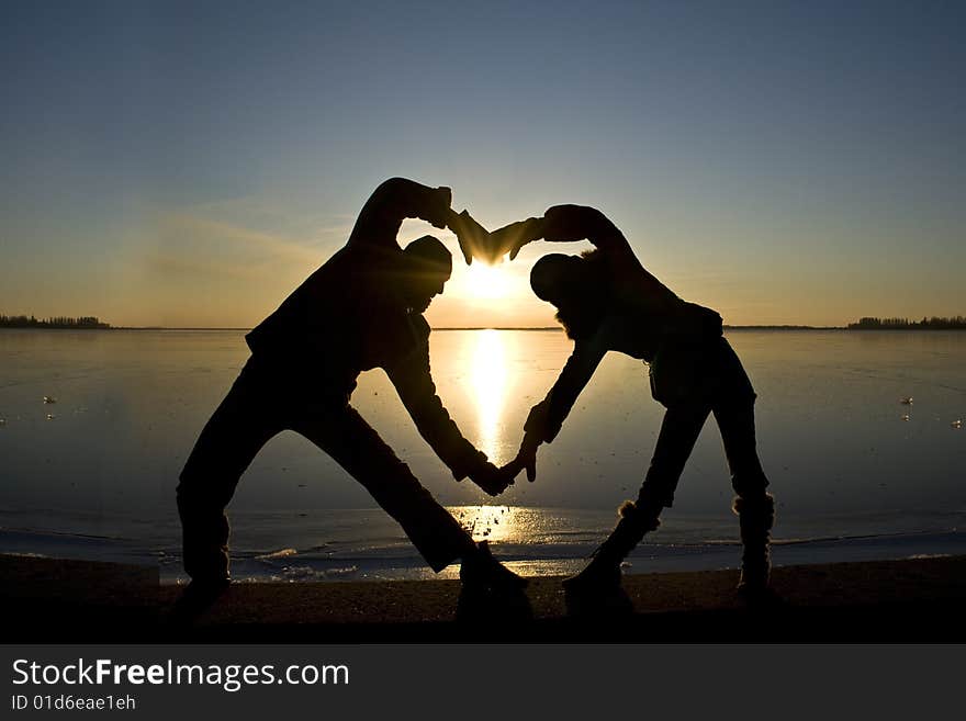 Silhouette men and women in the shape of heart