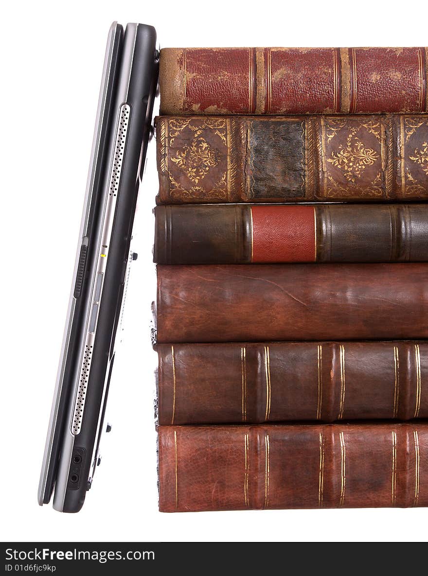 Old leather bound books with a laptop isolated on a white background