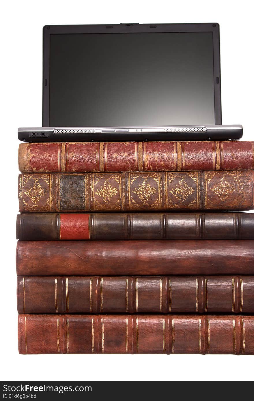 Old leather bound books with a laptop isolated on a white background