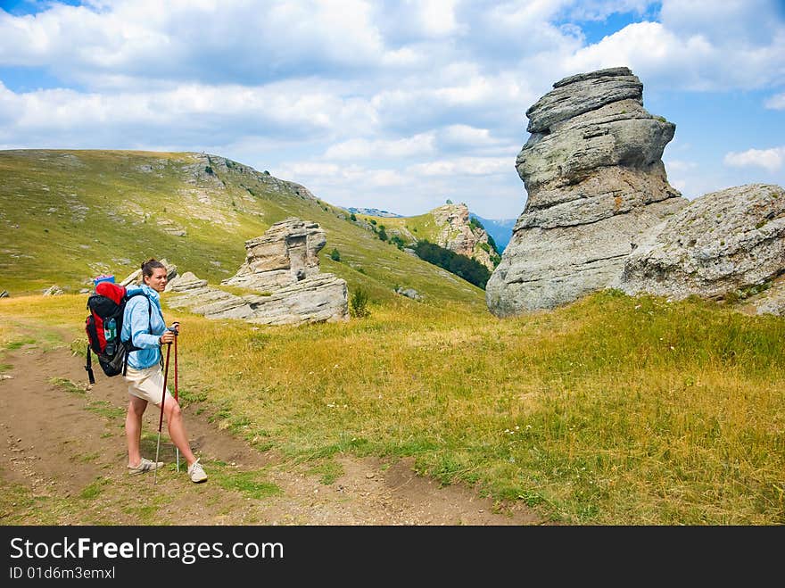 Hiker in mountains. Landmark - Ghost Valley, Demerdji, Crimea, Ukraine. Hiker in mountains. Landmark - Ghost Valley, Demerdji, Crimea, Ukraine.