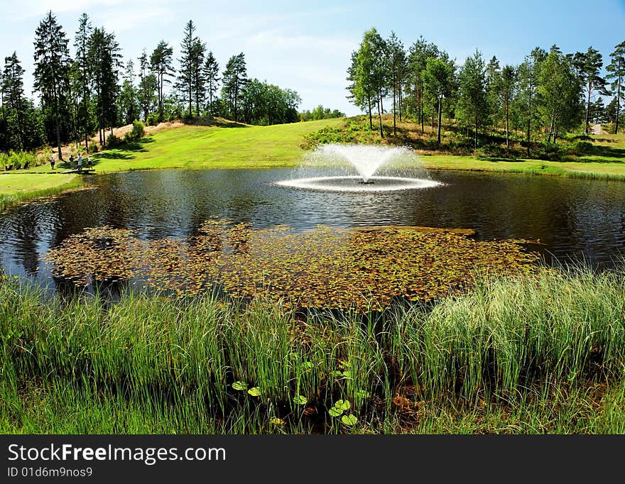 Pond with fontain at Bäkvattnets golf course in Sweden. Pond with fontain at Bäkvattnets golf course in Sweden