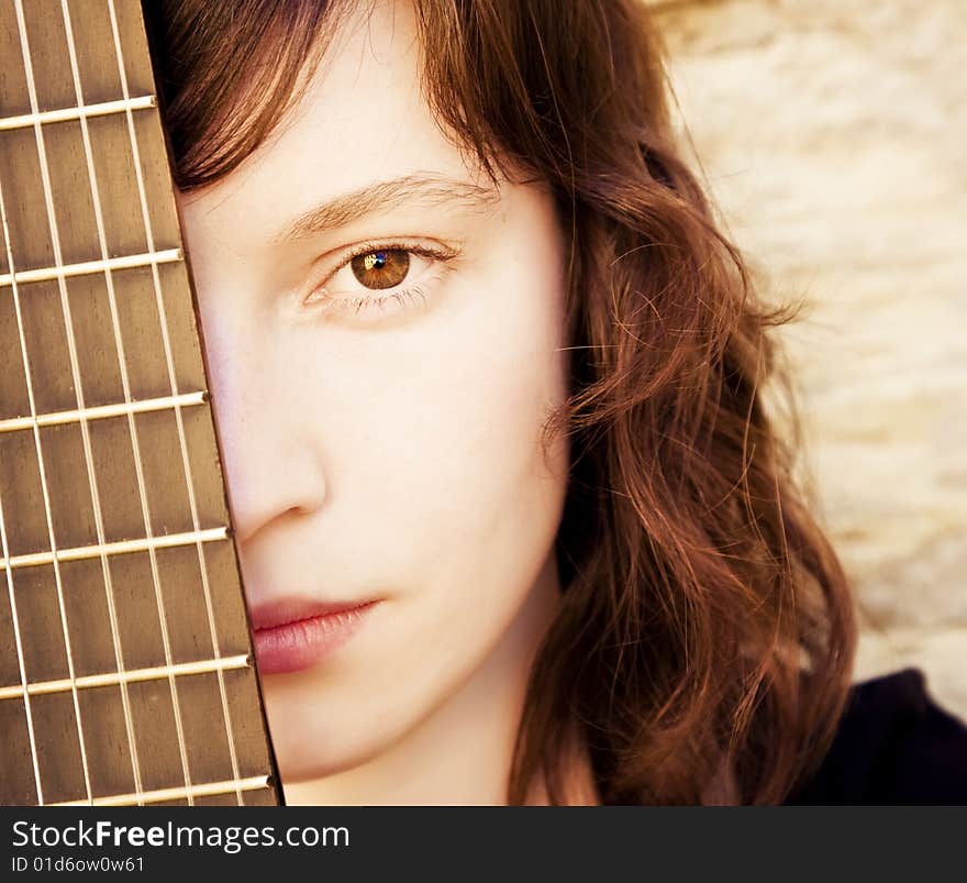 Woman behind fretboard. Square format. Woman behind fretboard. Square format.