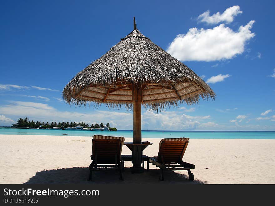 Straw umbrella against azure ocean. Straw umbrella against azure ocean