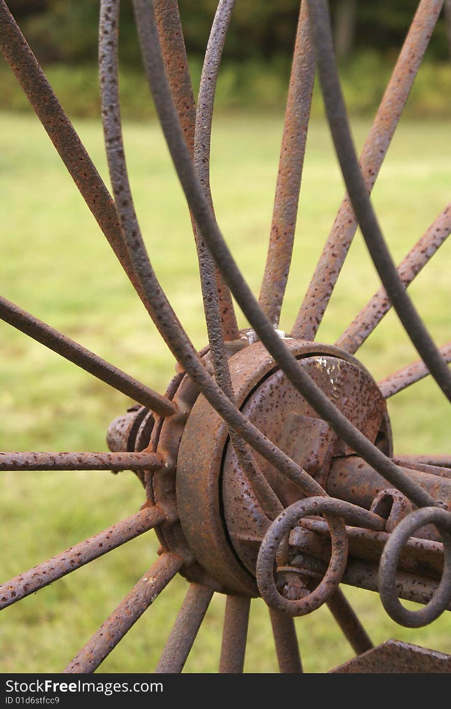 Close up of the wheel spokes and tines of an antique hay rake. Close up of the wheel spokes and tines of an antique hay rake.