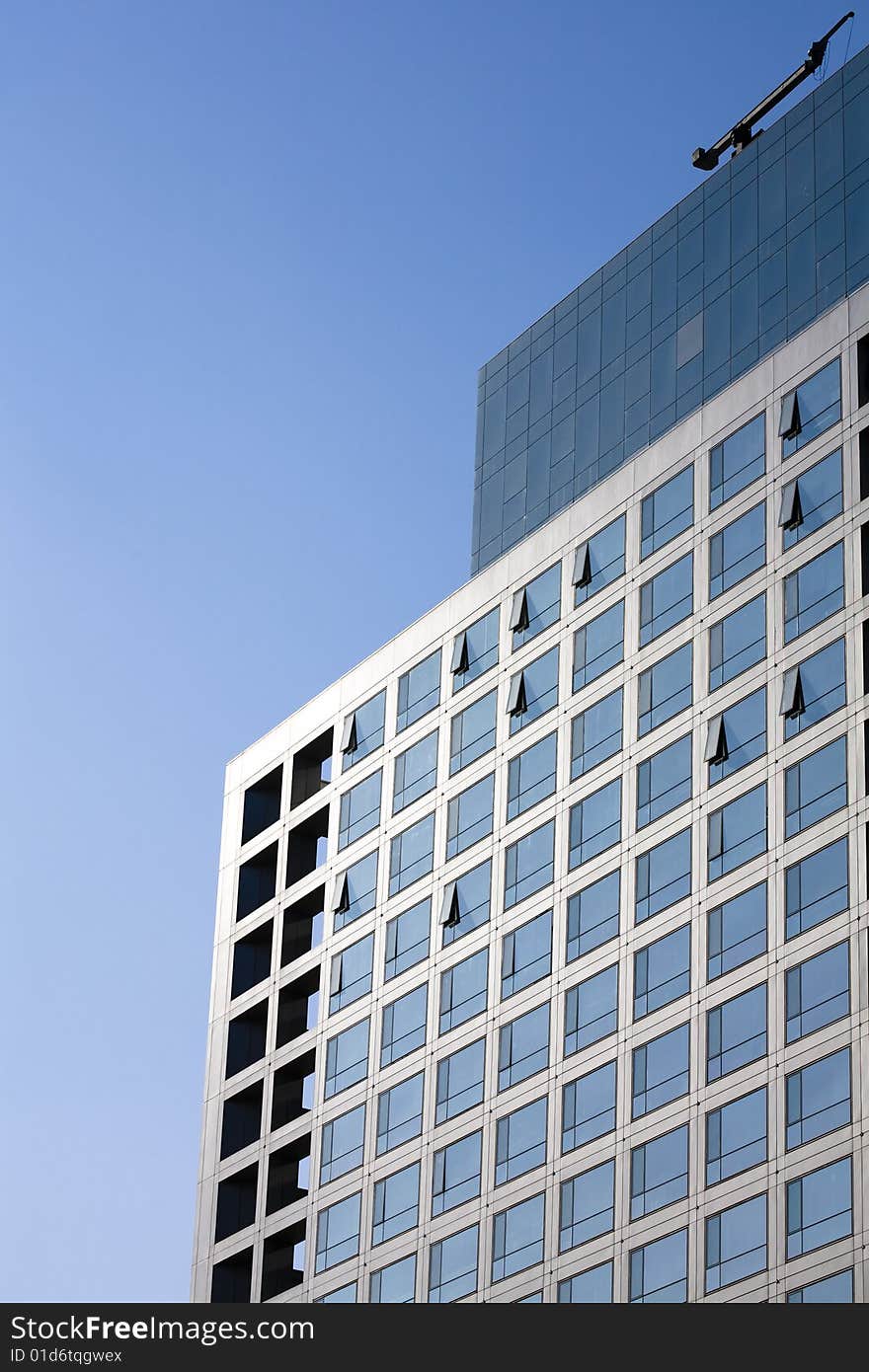 Windows by modern building in blue sky