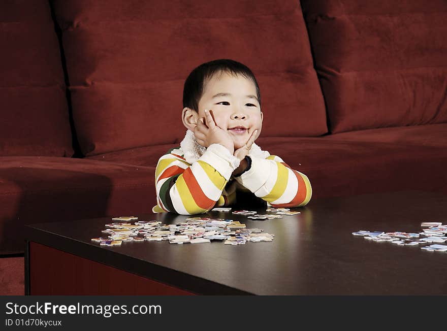 Boy playing jigsaw puzzle