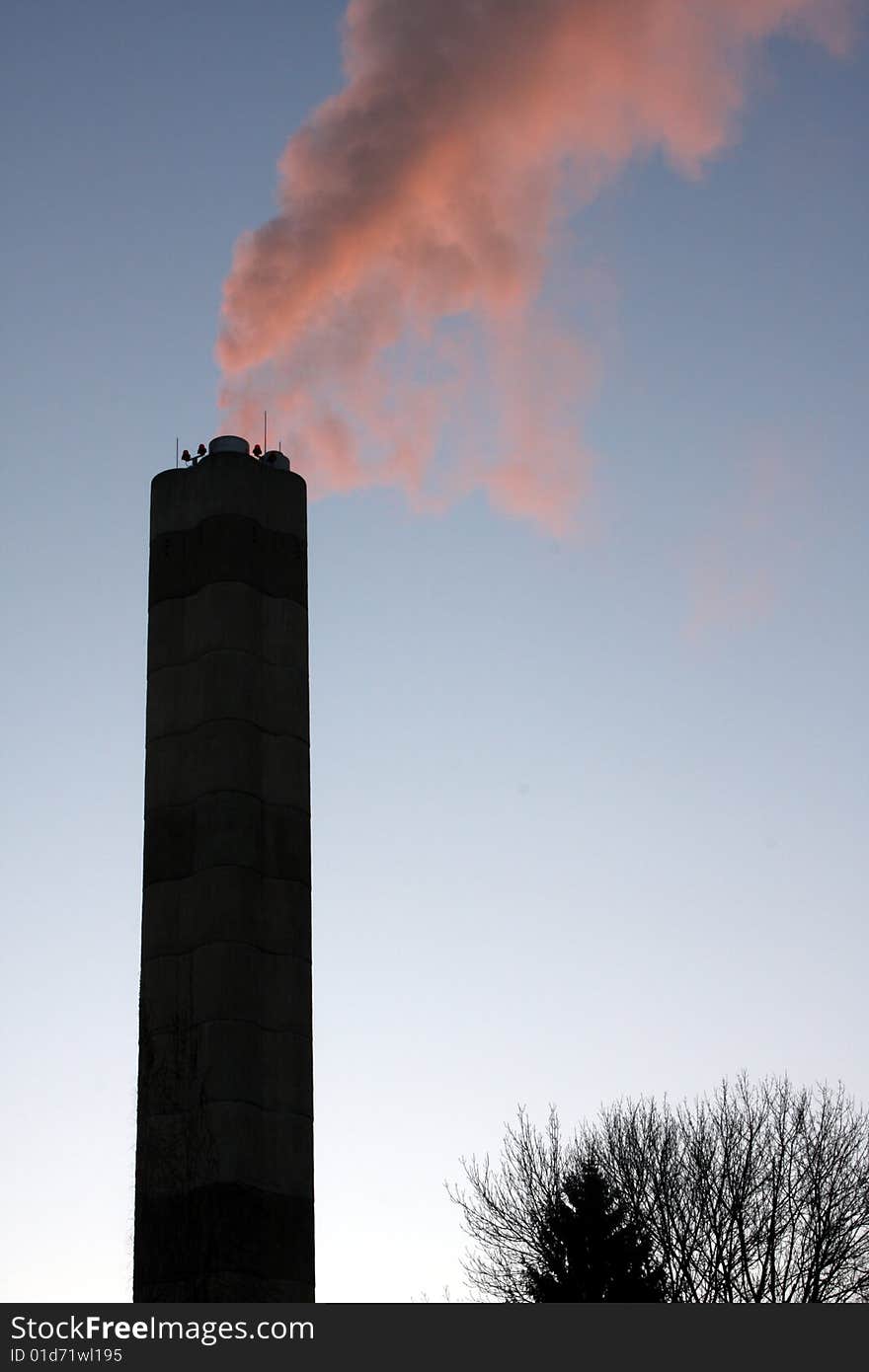 A smoke stack pouring out carbon based fossil fuels. A smoke stack pouring out carbon based fossil fuels