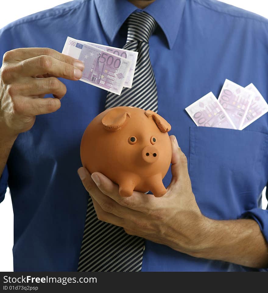 Businessman insert euro notes in clay piggy bank