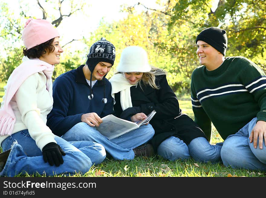 Four young caucasian male and female talking and having fun in park. Four young caucasian male and female talking and having fun in park