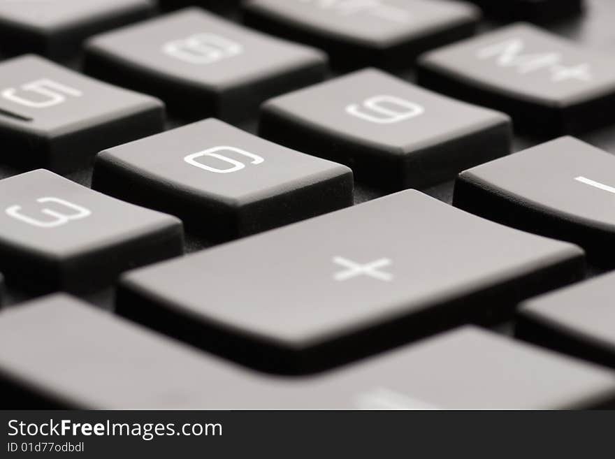 Closeup of a black calculator keyboard - Shallow DOF, low angle view