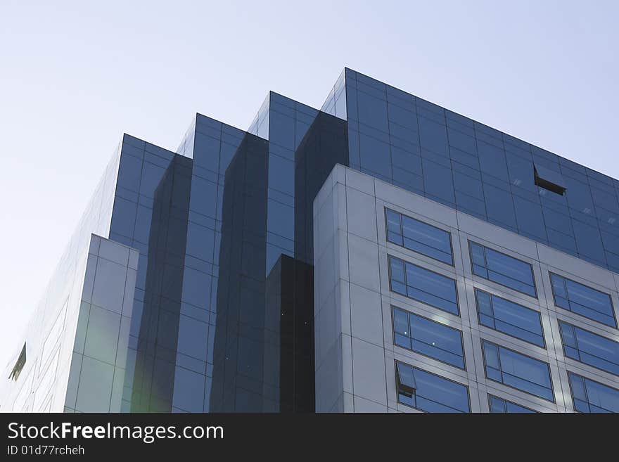 Windows by modern building in blue sky