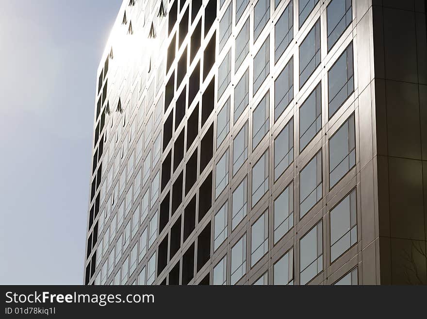 Windows by modern building in blue sky