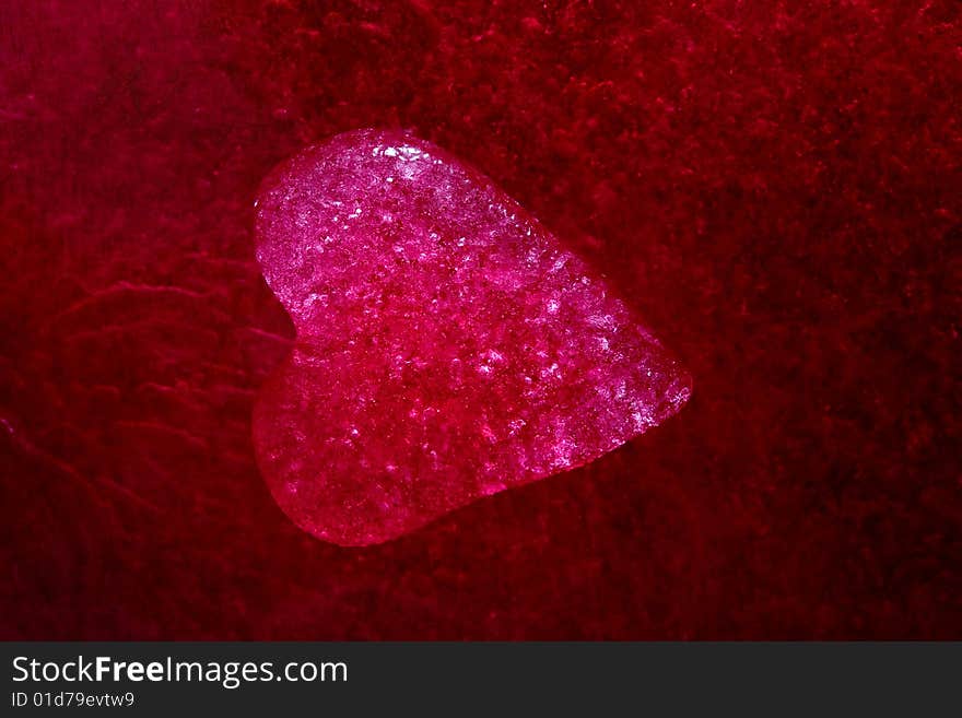 Stock photo: an image of a red icy heart on a purple background