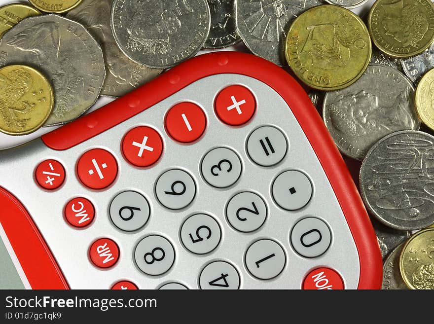 red and silver calculator with Australian dollar coins around it. red and silver calculator with Australian dollar coins around it