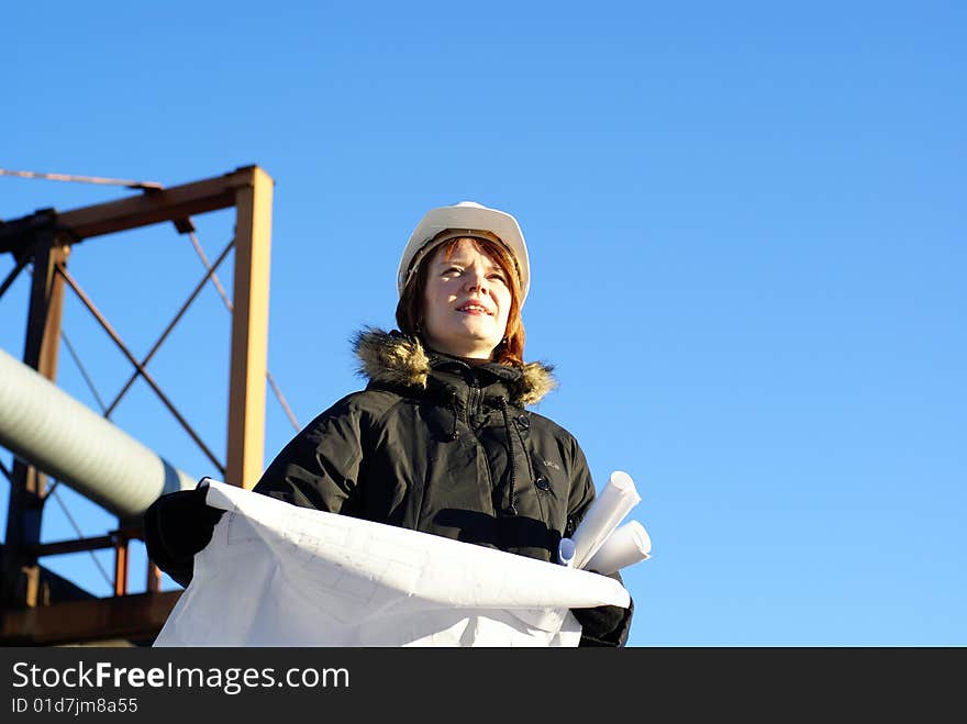 Young architect looking at blueprint