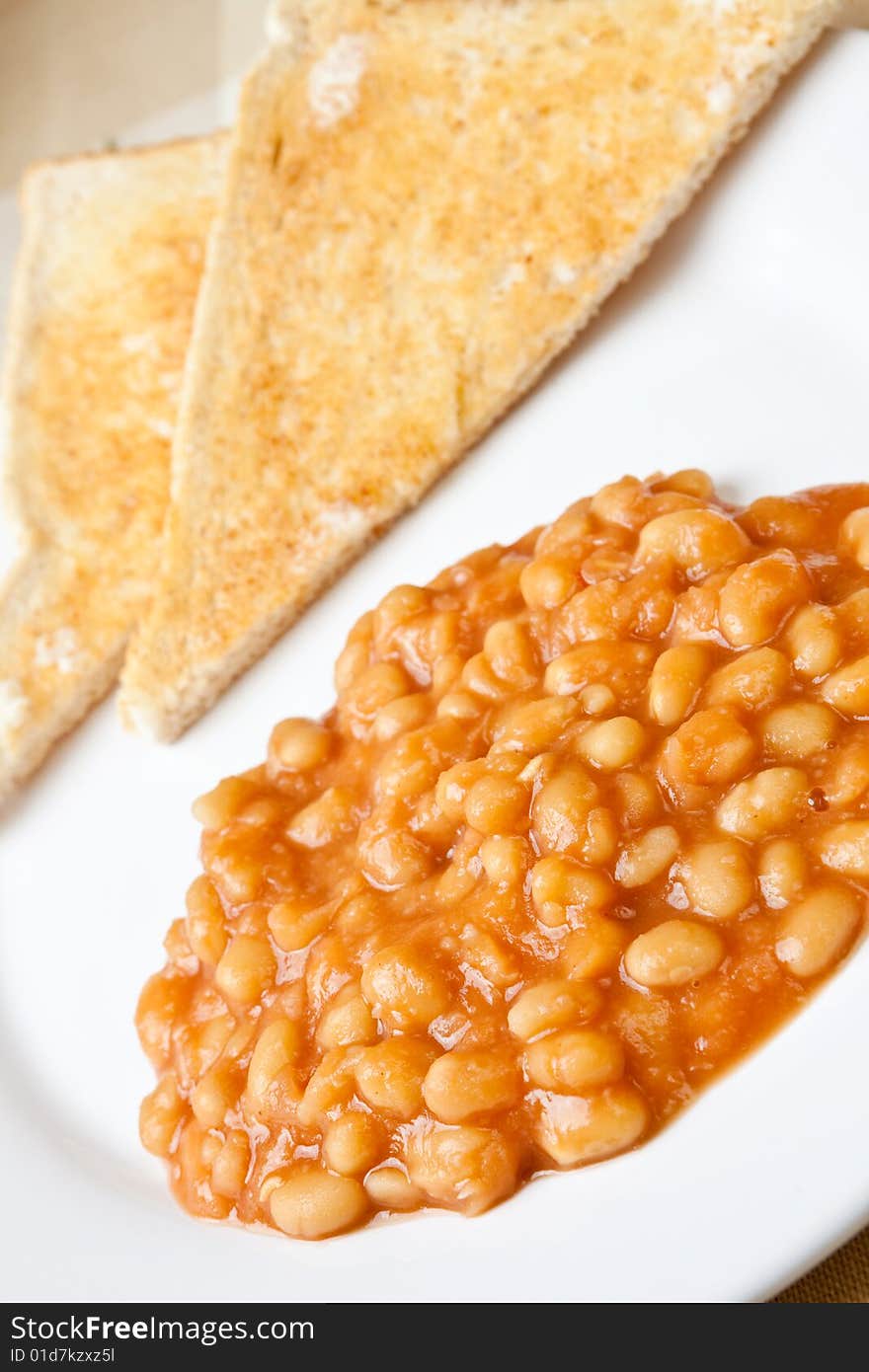 Delicious baked beans on toast on a plate