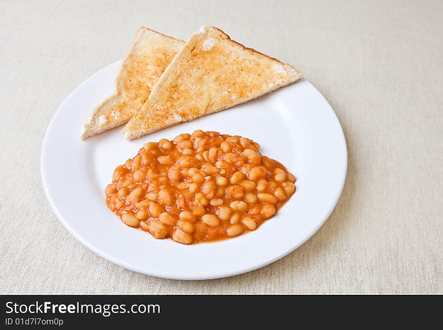 Delicious baked beans on toast on a plate