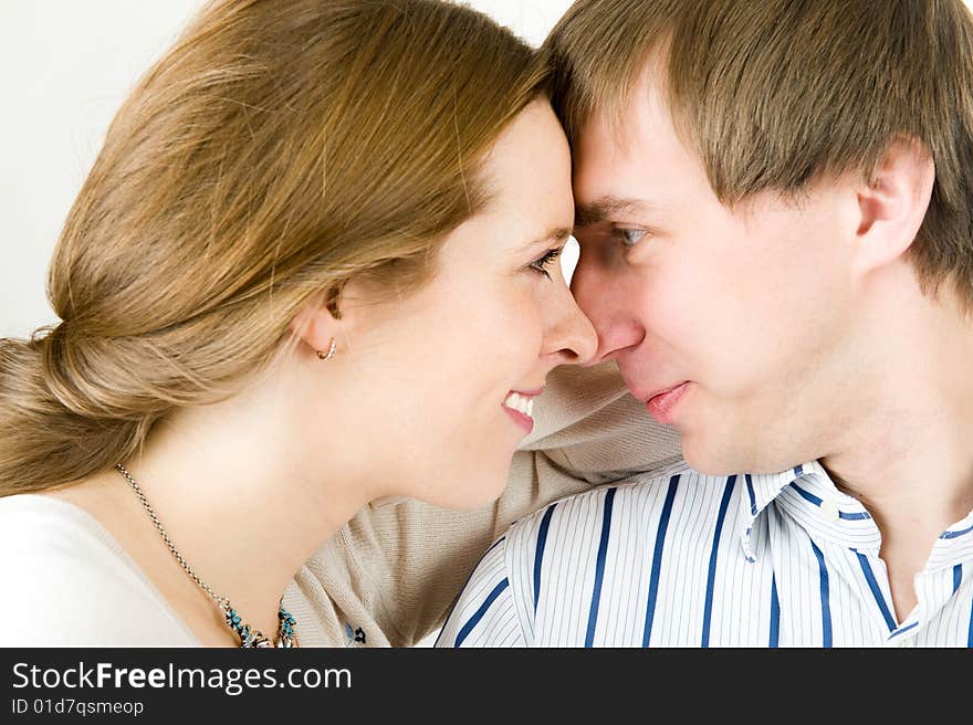 Closeup portrait of pretty couple. Isolated on white background