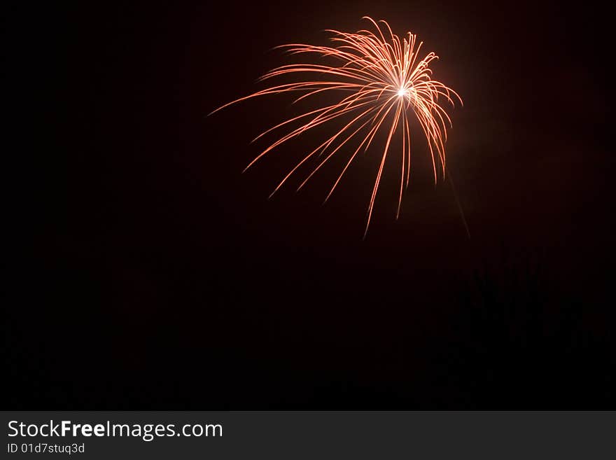 Fireworks, red star burst at the black sky on new years eve