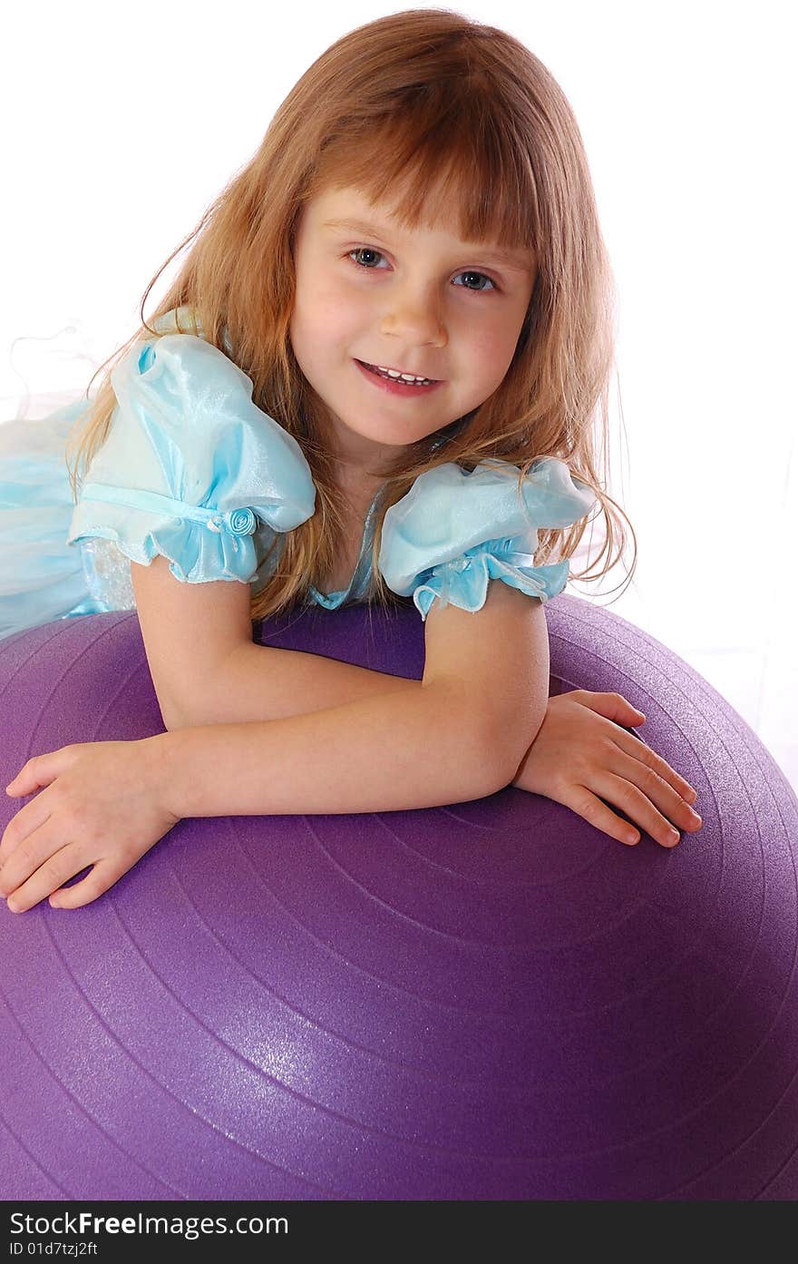 A 4 year old girl with a big violet ball. A 4 year old girl with a big violet ball