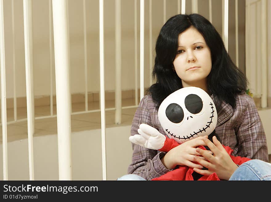 Sad teenager with a doll