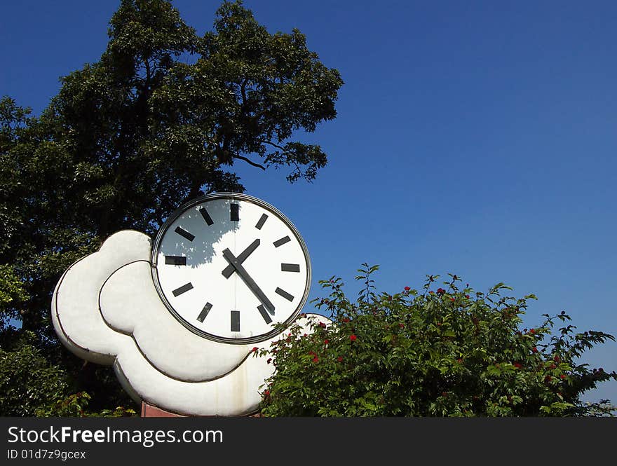 A clock in blue sky background