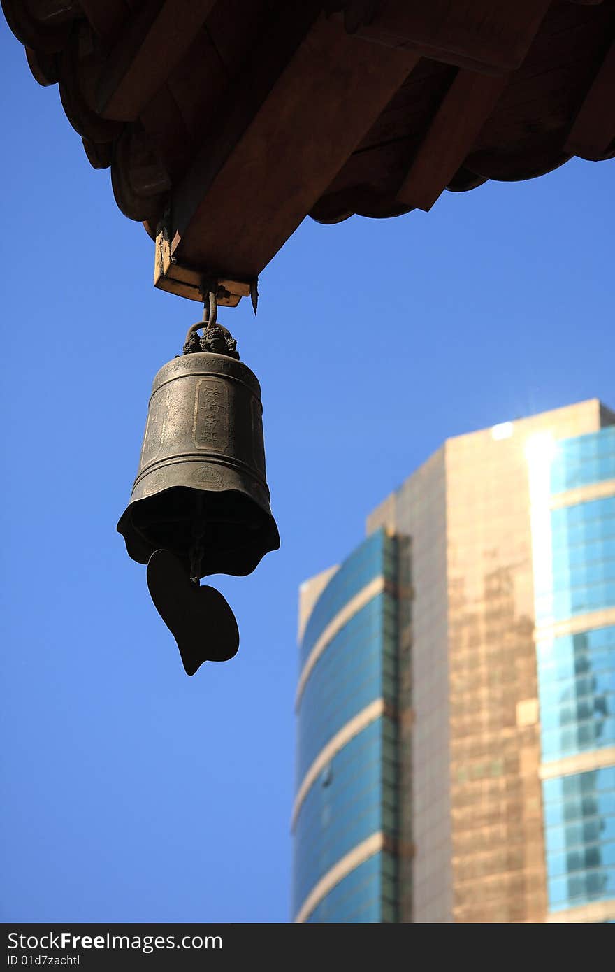 Temple bell and building with blue sky.