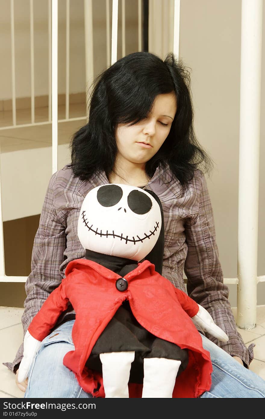 Sad teenager with a doll