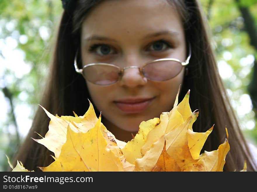 Pretty girl with autumn leaves