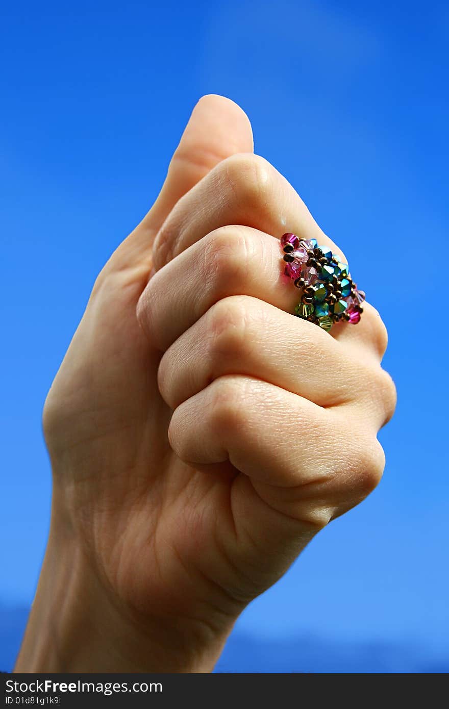 An image of a hand with a ring doing a positive gesture. An image of a hand with a ring doing a positive gesture