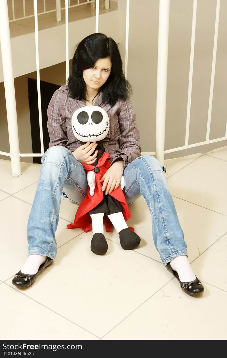 Sad teenager with a doll