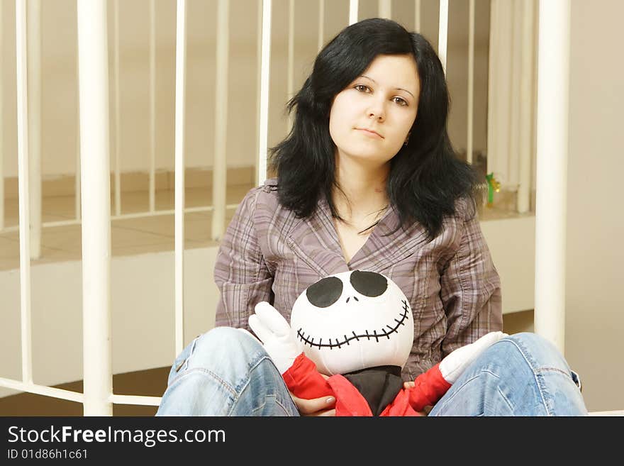 Sad teenager with a doll