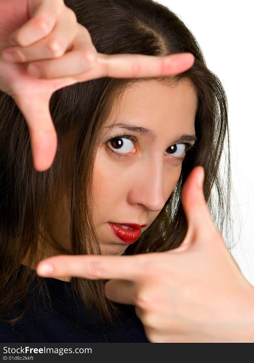 Portrait of a girl through the frame of the fingers