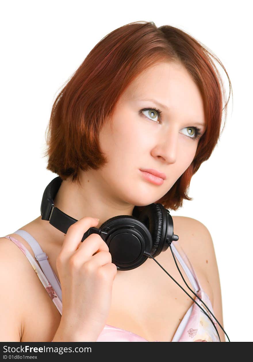 Attractive girl with headphones around her neck on a white background