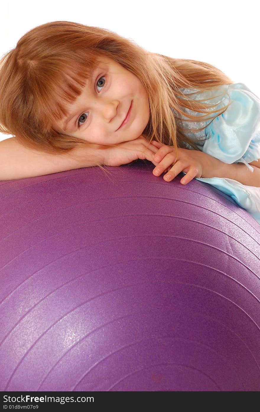 A 4 year old girl with a big violet ball. A 4 year old girl with a big violet ball