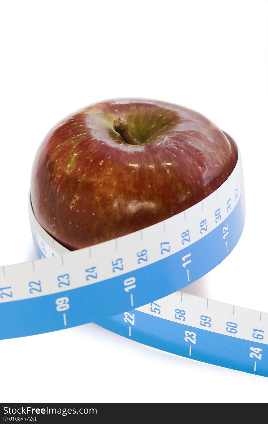 Helty eating - Red apple with tape measure against a white background. Helty eating - Red apple with tape measure against a white background.