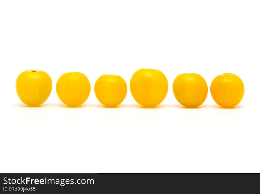 Yellow tomatoes on white background.