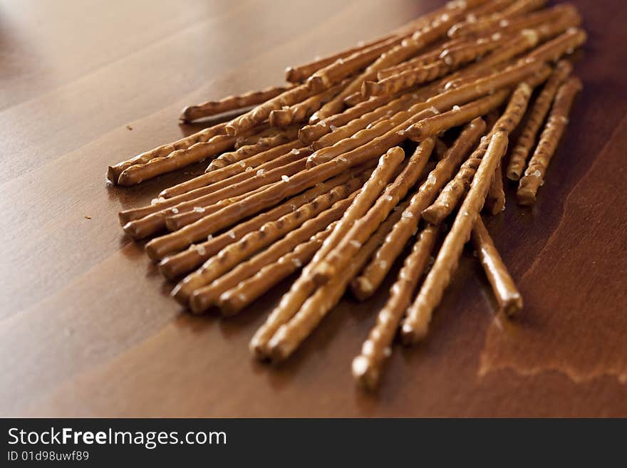 Pile of salted sticks on wooden background