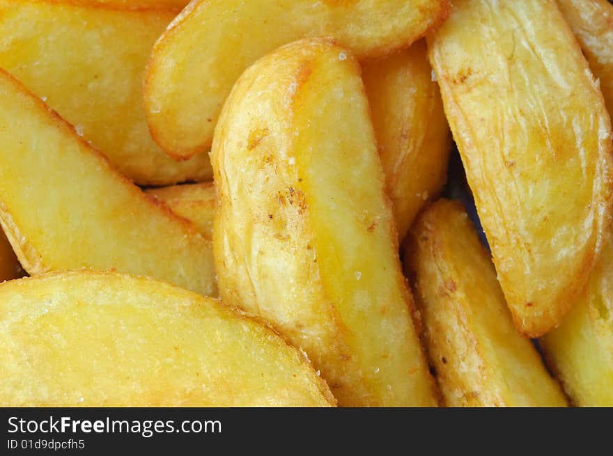 Fried potato closeup background, large slices