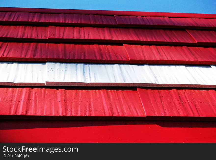 Close up of a portion of a red and white roof