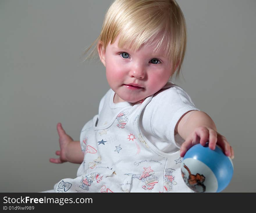 Cute and playful child gives ball