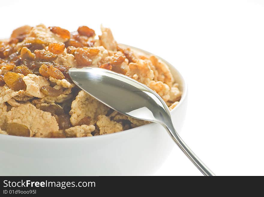 Bowl of cereal with raisins, milk and orange juice