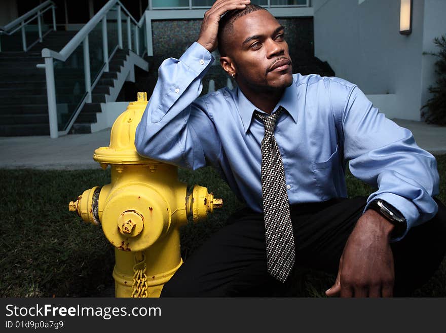 Young businessman by a yellow firehydrant. Young businessman by a yellow firehydrant