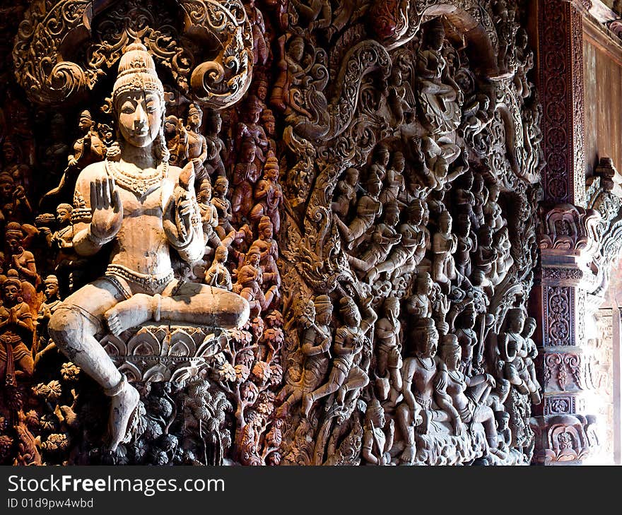 In Thailand in the city of Pattaya the sanctuary of truth is a wooden construction high of 105 meter covered with wooden carved sculpture; view of the sculpted roof. In Thailand in the city of Pattaya the sanctuary of truth is a wooden construction high of 105 meter covered with wooden carved sculpture; view of the sculpted roof