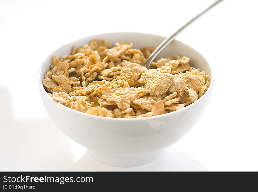 Bowl of cereal with raisins, milk and orange juice